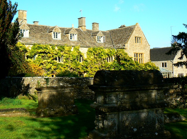 Stone exterior of Old Prebendal House in Shipton-under-Wychwood, seen across the churchyard.