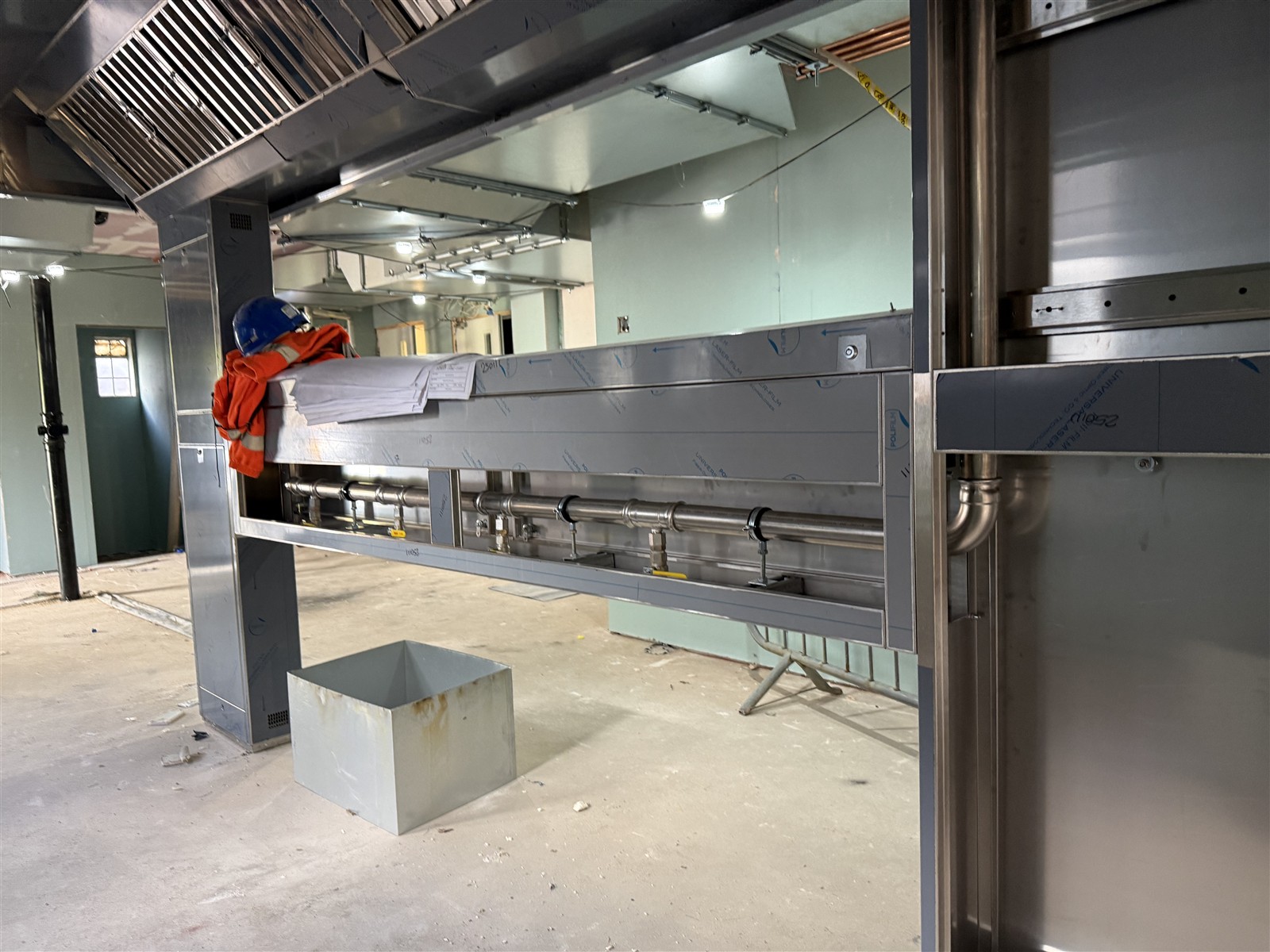 Commercial kitchen service structure and connected pipework during installation