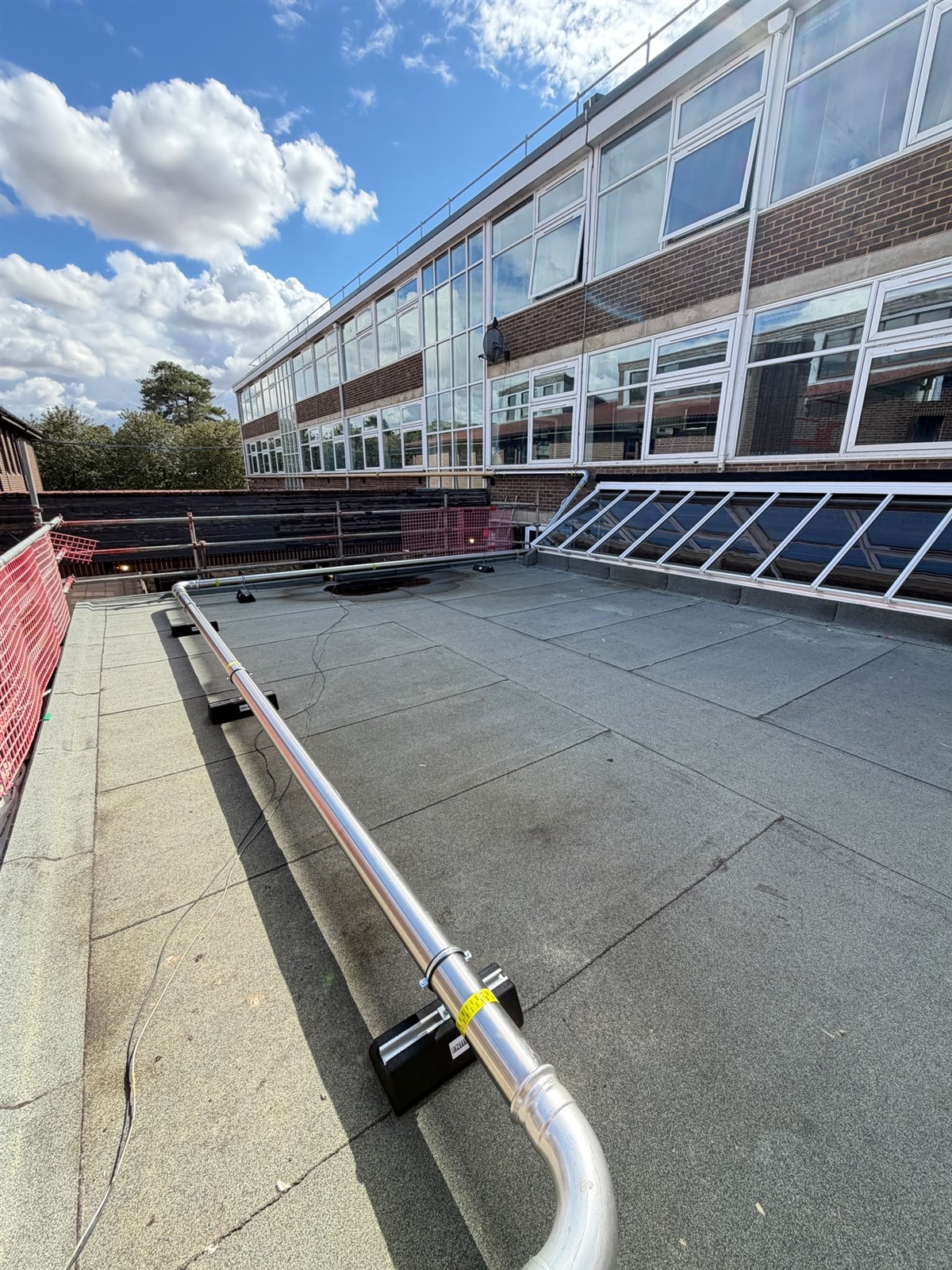 Stainless-steel gas main supported above the roof at Faringdon Community College