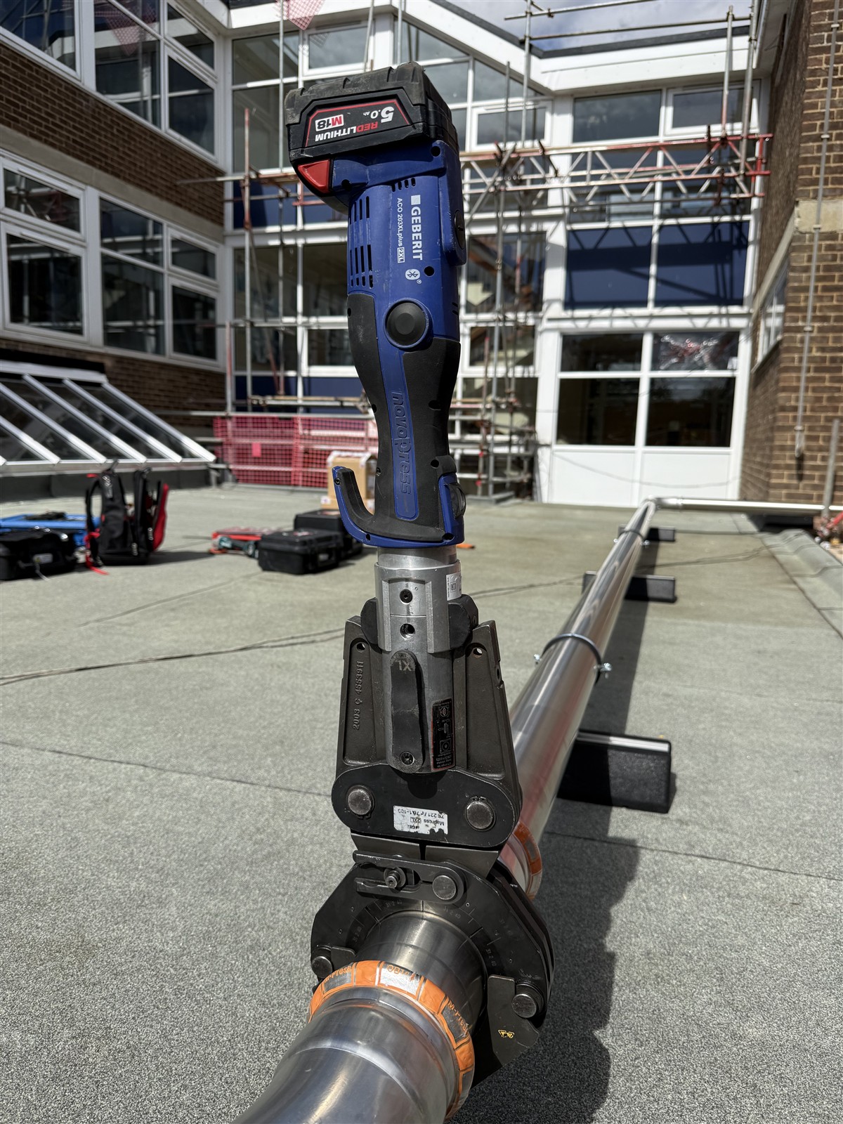 Press tool attached to a stainless steel rooftop gas pipe fitting at Faringdon Community College