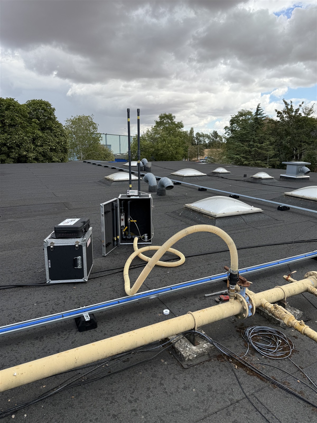 Test equipment and hoses beside the rooftop gas pipework at Faringdon Community College