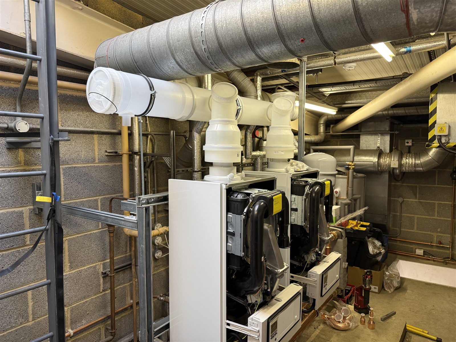Twin Vaillant boilers on their cascade frame with front casings removed during installation