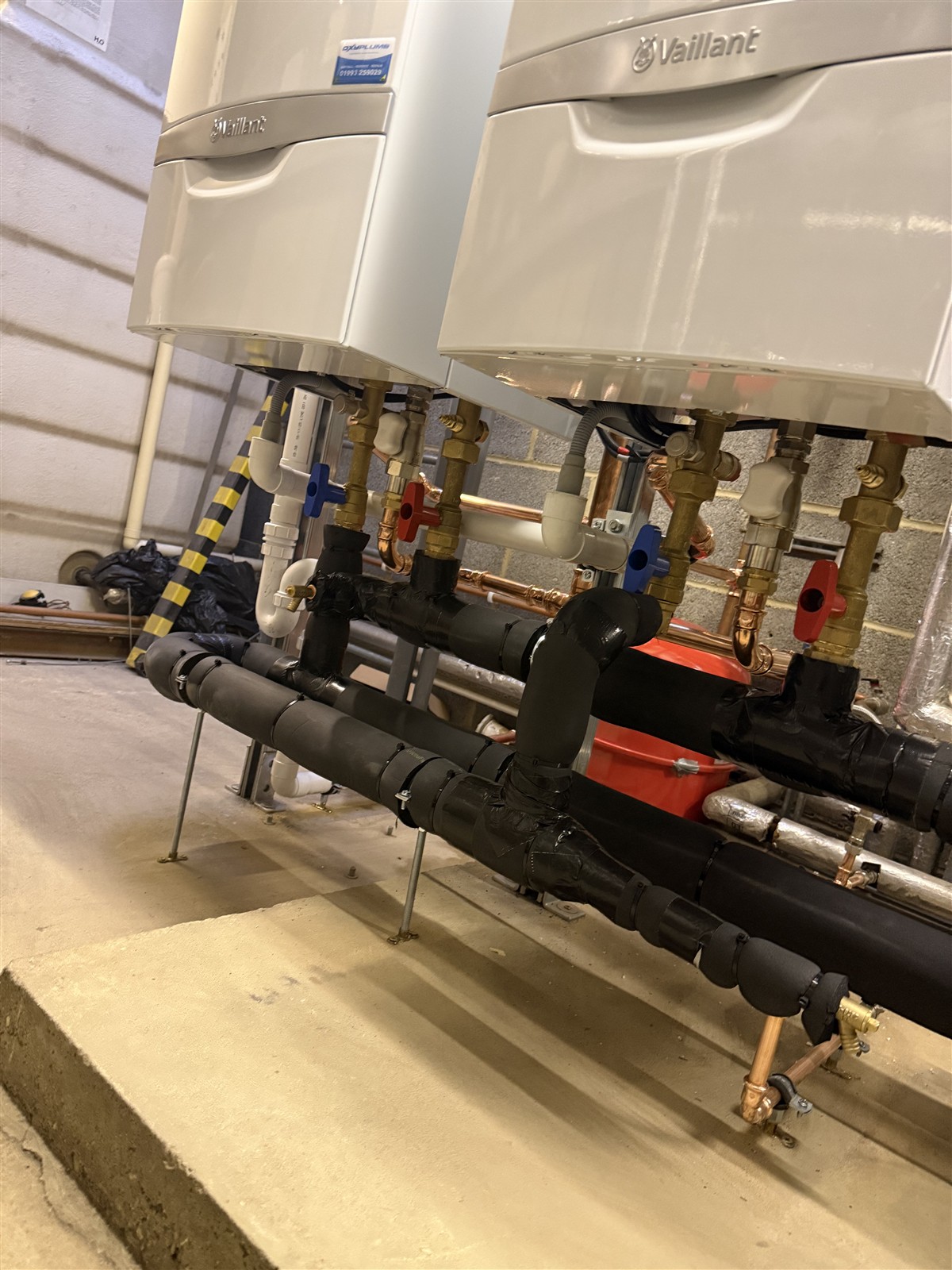 Close-up of boiler valves, circulation pump and insulated manifold at LTI Metaltech