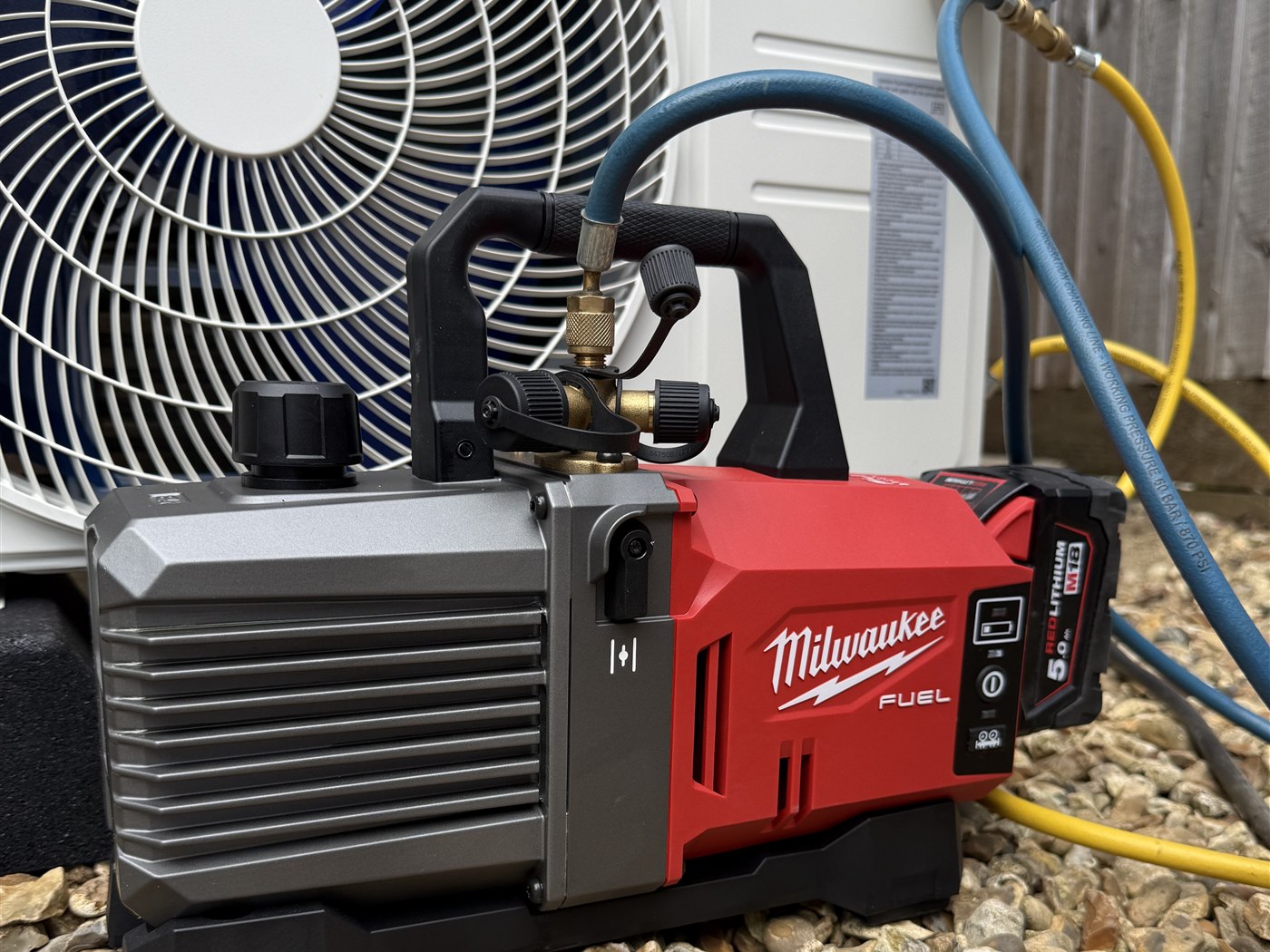 Milwaukee vacuum pump connected during an Oxyplumb air conditioning installation